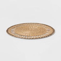 a round woven placemat on a white background