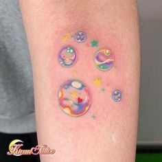 a person with tattoos on their arm and some water droplets in the air above them