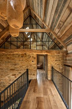 the inside of an old building with wooden floors and exposed ceilings, along with metal railings