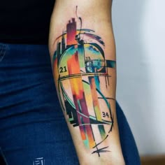 a woman's arm with a colorful abstract tattoo on the left side of her arm