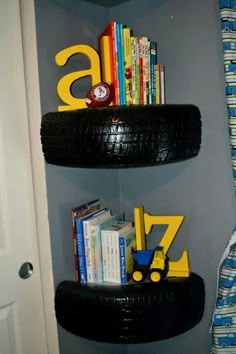 a book shelf made out of tires and some books on top of it in a room