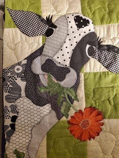 a quilted horse with a flower on it