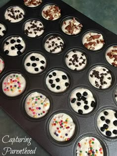 cupcakes with white frosting and chocolate sprinkles in a muffin tin