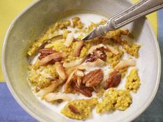 a white bowl filled with cereal and nuts