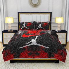 a bed with a red and black comforter on it