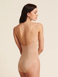 Capezio's seamless camisole undergarment includes nude and clear adjustable shoulder straps. The back neckline has six hook positions for versatile adjustment. The seamless Tactel Nylon blend contours and shapes the dancer's body. Moderate cut leg line. Machine wash in cold water, hang dry. Capezio Adult Seamless Camisole Undergarment Nude XL 3680 Second-skin Bodysuit With Spaghetti Straps And Built-in Bra, Shapewear Leotard With Built-in Bra, Second-skin Camisole Bodysuit With Built-in Bra, Elegant Seamless Bodysuit With Scoop Neck, Elegant Seamless Leotard, Elegant Shaping Leotard With Built-in Bra, Solid Color Shaping Leotard With Seamless Construction, Second-skin Shapewear With Built-in Bra And Full Coverage, Summer Shapewear Camisole With Built-in Bra