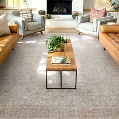 a living room with two couches and a coffee table in front of a fireplace