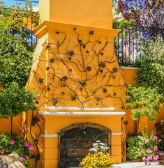 an outdoor fireplace in the middle of a garden