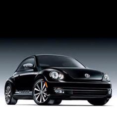 a black volkswagen beetle parked in front of a white background