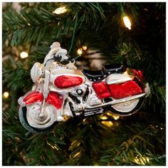 a red and white motorcycle ornament hanging from a christmas tree