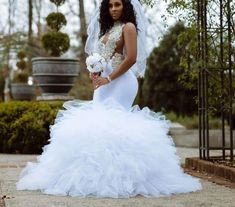 a woman in a wedding dress posing for the camera