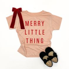 "*ITEM: Infant/Toddler T-Shirt with \"MERRY LITTLE THING\" printed in red ink. Tee Color Options: Heather Peach or White. *SIZING: For the best possible fit, I recommend using the measurements in the chart listed. If your little one is nearing the end of wearing their size, please size up! *CARE: Gentle wash in cold water. Lay flat to dry. *PROCESSING TIME: 5-7 Business Days. Click here to shop all our holiday tees: https://www.etsy.com/shop/MadeWithMercyShop?ref=seller-platform-mcnav&section_id Christmas Shirts Vinyl, Toddler Christmas Shirt, Holidays With Toddlers, Christmas Shirts For Kids, Rainbow Shirt, Screen Printing Shirts, Merry Christmas Shirts, Retro Tee, Holiday Baby