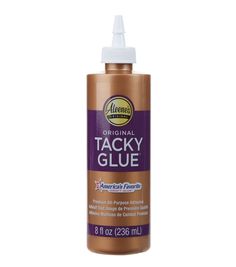 a bottle of tacky glue on a white background with an orange and purple label