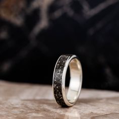 The Stargazer was inspired by Galileo, who discovered the Milky Way and those who search the night sky for the immense beauty it holds. We combine a sustainable sourced 100% recycled silver ring base with meteorite to craft this stunning ring that glimmers like the night sky. Our ring crafter's hand place silver flakes into the Muonionalusta Meteorite dust inlay to create a design that is truly out of this world. 
The Stargazer Features:

SCS certified 100% recycled silver ring base
Muonionalust Mens Silver Wedding Bands, 10k Gold Ring, Meteorite Ring, Special Ring, The Milky Way, Silver Wedding Bands, 18k Gold Ring, The Night Sky, Recycled Silver