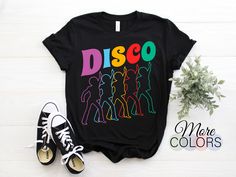 Disco T-Shirt 70s Disco Themed Shirt Vintage Retro Dancing, 1970's Style Graphic Design Throwback Disco Music Lover Gift Groovy Tee Dance Perfect Party Outfit Dancing. ✔️ How To Order 1 - Please review all size charts pictures on the listing for the information on available sizes, styles, and colors. 2 - Select the style and size from the first drop-down menu (Style/Size). 3 - Select the color of the item using the following drop-down menu (Color). ✔️ This design is available in Men, Women, Unisex, Youth, Kids, Toddlers, and Baby sizes. ✔️ This design can be printed on a T-Shirt, V-Neck, Tank Top, Racerback, Long Sleeve Shirt, Sweatshirt, and Hoodie. ✔️ If you need further information. We are online 24/7. Send us a message! We respond within a few hours. We offer high-quality fabrics combi Retro Dancing, Groovy Tees, Disco Music, 70s Disco, 1970s Fashion, Gift For Music Lover, Music Lover, Dance Party, Design Graphique