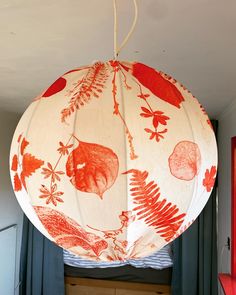 a red and white paper lantern hanging from the ceiling