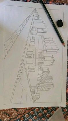 a drawing of a building on top of a piece of paper next to a pencil