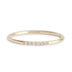 a gold band with five diamonds on it