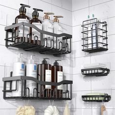 two black shelves with soap, lotion and other bathroom items on them against a white tiled wall