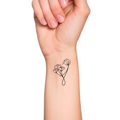 a woman's arm with a small tattoo on it