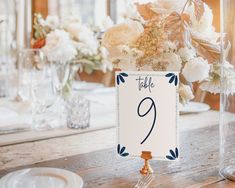 the table numbers are displayed in vases on the dining room table for guests to enjoy