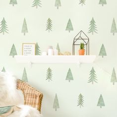 there is a wall with trees on it and a shelf in the corner that has a potted plant