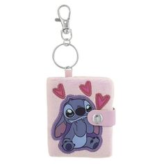 a keychain with stitching on it that has a cartoon character