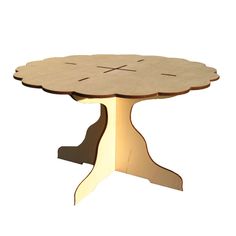 a wooden table with an intricate design on the top and base, made out of plywood