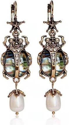 About this item 2"L Vintage: This vintage looking Scarab Earrings  jewelry captures the unique and unusual feel of the era. The vintage accessories for women match clothing and complete any vintage look or outfit Unique: This unique jewelry for women features a scarab with an abalone shell and gold tone metal that make up the dangle drop earrings. These are true women statement earrings for every occasion Dangly: These vintage looking costume jewelry earrings show off the style of the period. The dangling bug jewelery offers an eye-catching and cool addition to any boho or fashion decade event Insect: These insect earrings for women make the perfect accessories for women jewelry who want to be noticed. The women's beetle earrings with stone are chunky and cute. Bijoux Art Nouveau, Goth Earrings, Insect Jewelry, Shell Earrings, Sea Glass Jewelry, Stone Earrings, Vintage Earrings, Crystal Jewelry, Jewelry Stores