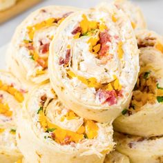 there are many different types of food wrapped in bread on the plate and ready to be eaten