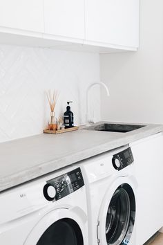 a washer and dryer in a white kitchen