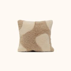 a pillow that has been made out of sheepskin and is sitting on a white surface