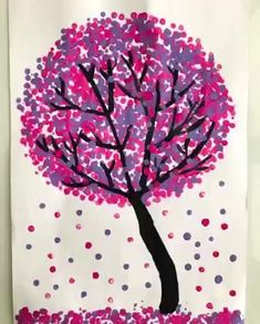 a paper bag with a tree made out of pink and purple confetti dots