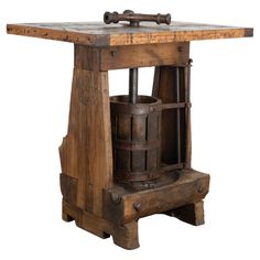 an old fashioned wooden table with a bucket on it's top and two springs attached to the base