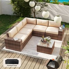 an outdoor furniture set on a deck with white lanterns and lights hanging from the ceiling