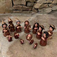 a group of figurines sitting on top of a stone floor