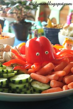 an octopus made out of carrots and cucumber slices on a white plate