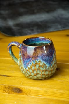 a coffee cup sitting on top of a wooden table