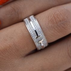 a woman's hand with a diamond ring on it