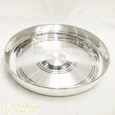 an empty silver plate on a white surface