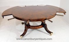 an oval dining table with four leaves on each end