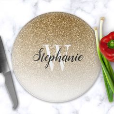 there is a plate with the word stephanie on it next to some vegetables and a knife