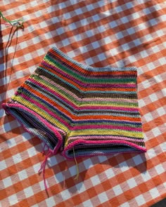 a crocheted dishcloth is laying on a picnic table