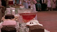 a table topped with lots of different types of cakes and desserts next to each other