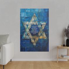 a living room with a white couch and a painting on the wall that has a star of david in it