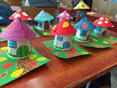 some paper houses are sitting on top of a table