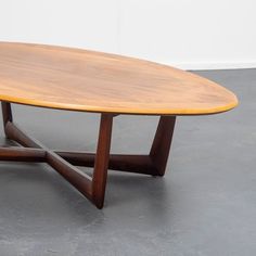 a wooden table sitting on top of a gray floor