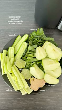 a plate with celery, cucumbers, and other vegetables on it