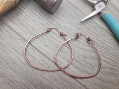 These rustic hammered copper hoop earrings are the perfect blend of earthy and boho style. Crafted from genuine copper or sterling silver wire and meticulously hammered by hand, each pair has a unique texture and organic feel.  Choose between copper and sterling silver. Copper exudes a warm, earthy feel with its rich, reddish-brown tones, while sterling silver offers a cooler, sleek elegance with its bright, polished shine. The round hoop design makes them versatile for any outfit.  These earrings make a thoughtful birthday gift or a meaningful present for your girlfriend or wife, whether for a special occasion or just because. Gift Ready: Comes packaged in a beautiful, eco-friendly box, perfect for gifting on birthdays, anniversaries, or any special day. Material: High-Quality Copper Wire Hammered Hoop Earrings, Hoop Design, Earrings Geometric, Hand Shapes, Brown Tones, Reddish Brown, Hammered Copper, Jewelry Earrings Hoops, Gift For Wife