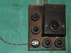 an electrical box with several different types of wires and plugs attached to the wall